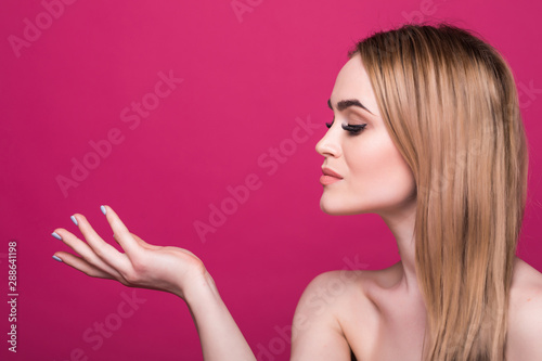 Beautiful face of a young caucasian woman skin care concept, isolated on pink background