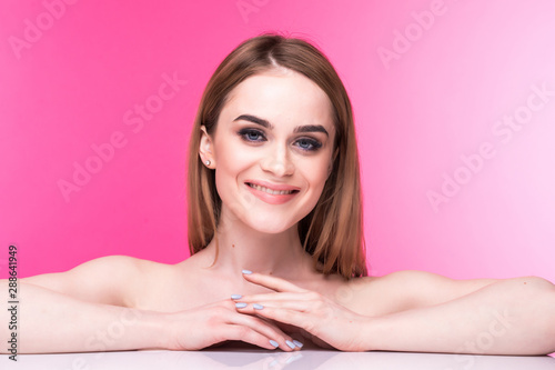 Beautiful happy woman with make up skin care concept over pink background