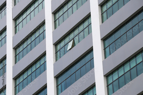 Glass windows of high buildings. Pattern of windows that line the building.