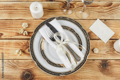 Beautiful table setting on wooden table from above