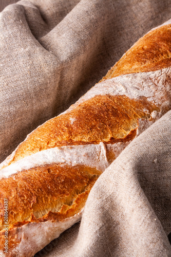 Hot french bagette on roustic wrap in boulangerie. Bred, food, closeup photo