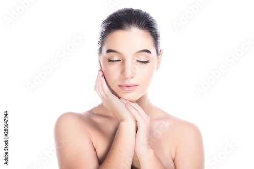 Beauty woman face isolate in white background. Young caucasian girl, perfect skin, nude, message, spa, beauty treatment concept. Hand touch cheek, eye close.