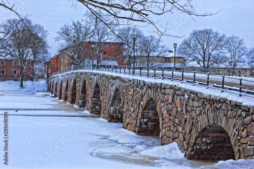 Bridge over the river in winter, old stonebridge in Karlstad, Sweden.