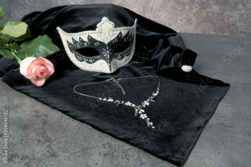 Photo of elegant white and black venetian, carnaval mask over dark background. Vintage photo photo