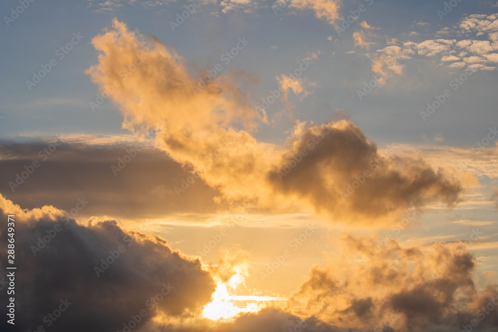Close up of a drramatic golden blue sunset or sunrise with clouds.