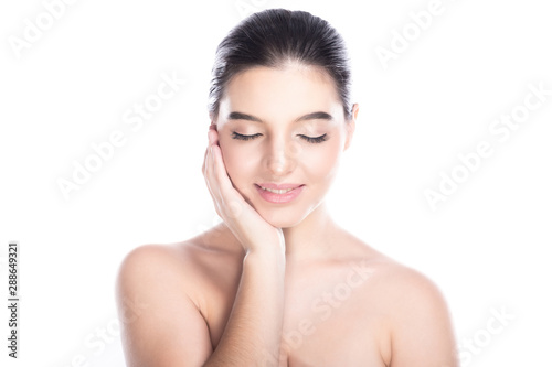 Beauty woman face isolate in white background. Young caucasian girl  perfect skin  cosmetic  spa  beauty treatment concept. Right hand on cheek  eye close  smile.