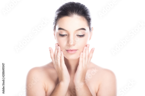 Beauty woman face isolate in white background. Young caucasian girl, perfect skin, cosmetic, spa, beauty treatment concept. Wash face motion, looking down.