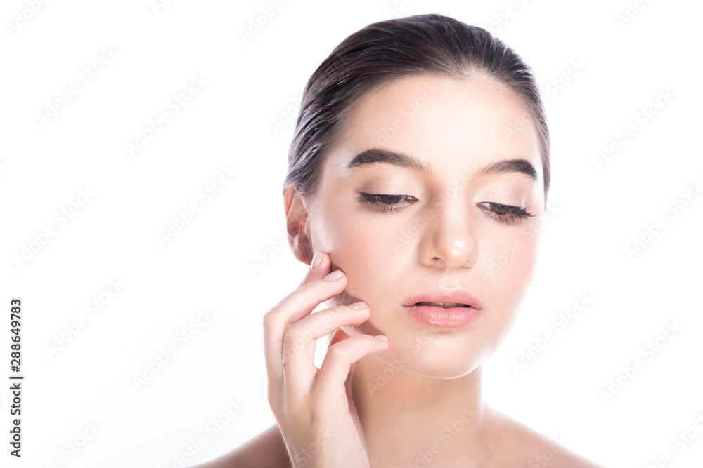 Beauty woman face isolate in white background. Young caucasian girl, perfect skin, cosmetic, spa, beauty treatment concept. Fingers touch face looking down.