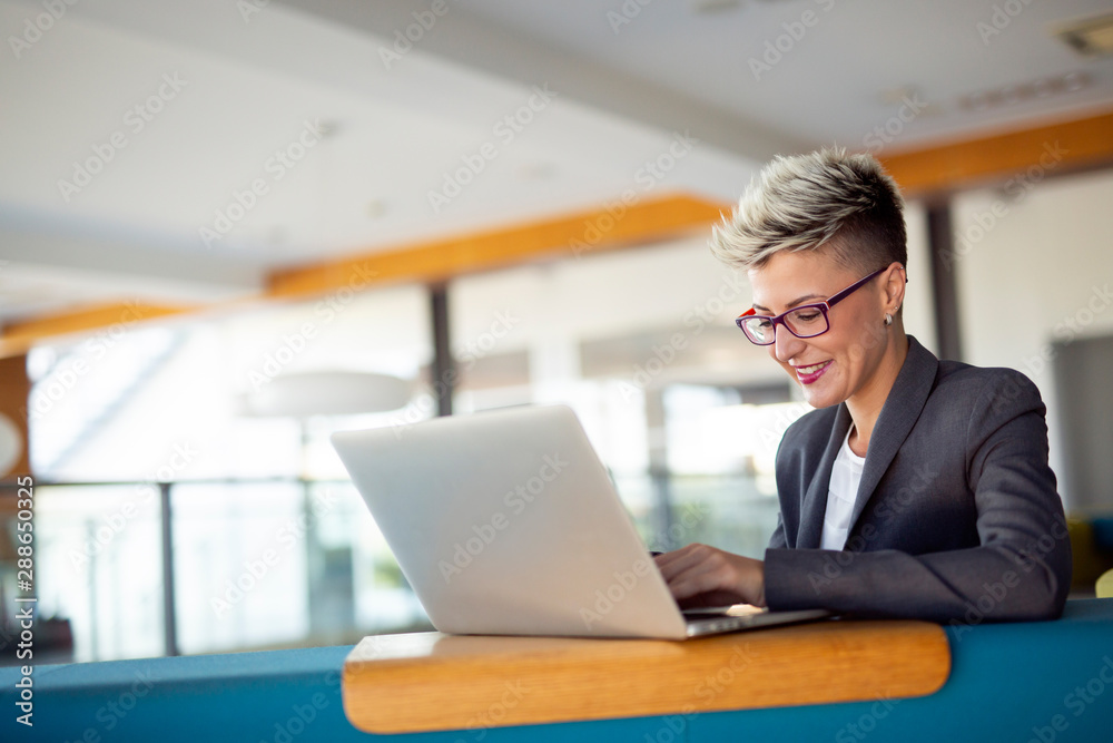 Attractive young female architect working on laptop Attractive young female architect working on laptop