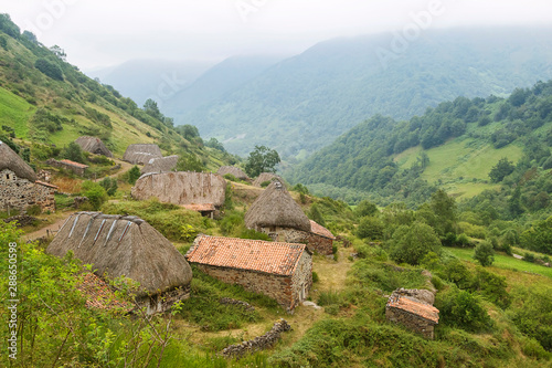 La Pornacal hiking route in Somiedo natural park, Spain, with straw roof houses photo