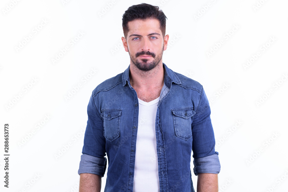Fototapeta premium Young handsome bearded hipster man looking at camera