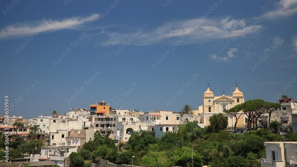 Panorama of the town of Forio d'Ischia, near Naples. The church of San Vito Martire with the blue sky and clouds in the background. Panorama of the town of Forio d'Ischia, near Naples. The church of San Vito Martire with the blue sky and clouds in the background.