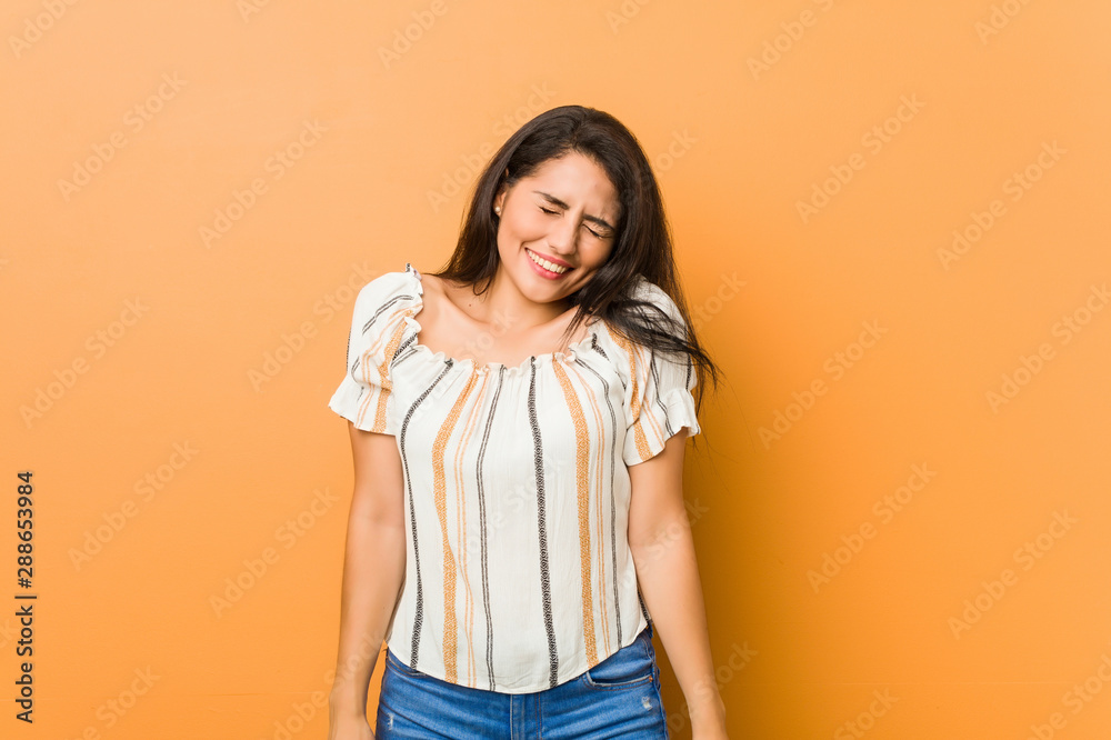 Young curvy woman laughs and closes eyes, feels relaxed and happy. Young curvy woman laughs and closes eyes, feels relaxed and happy.