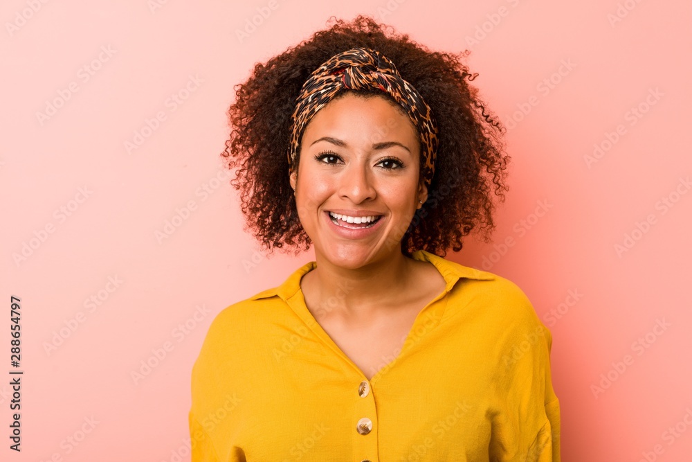 Young african american woman against a pink background Young african american woman against a pink background