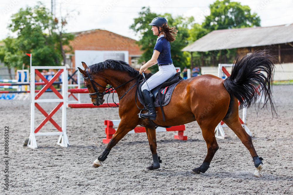Young female horse rider on equestrian sport event Young female horse rider on equestrian sport event