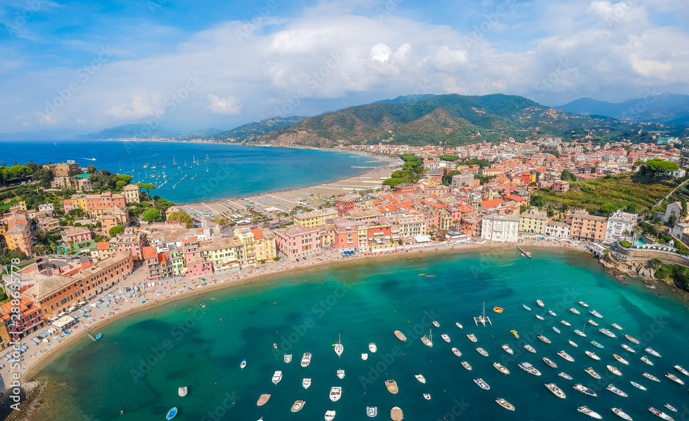 Sea aerial landscape in Sestri Levante, Liguria, Italy. Scenic fishing village with traditional houses and clear blue water. Summer vacation rich resort with picturesque harbour and nice sand beach