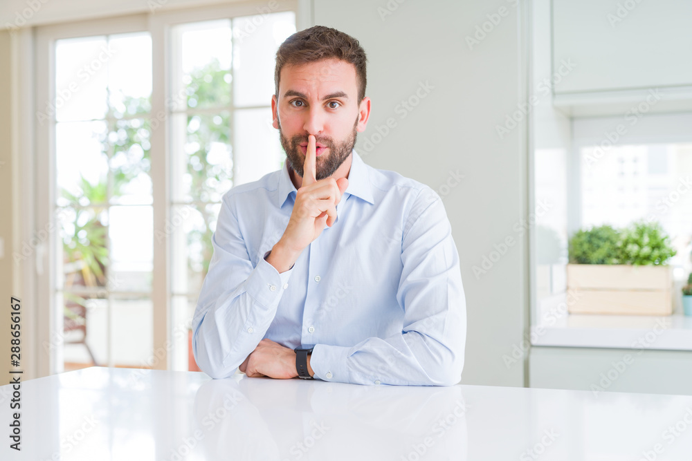 Handsome business man asking to be quiet with finger on lips. Silence and secret concept. Handsome business man asking to be quiet with finger on lips. Silence and secret concept.