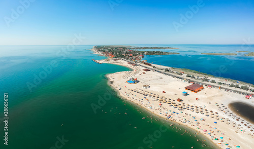 Panorama of sea shore in Berdyansk, South Ukraine, Europe. Resort city with nice sand beach and clear blue sea. Famous travel destination, ideal place for comfort vacation on Azov Sea. Drone photo