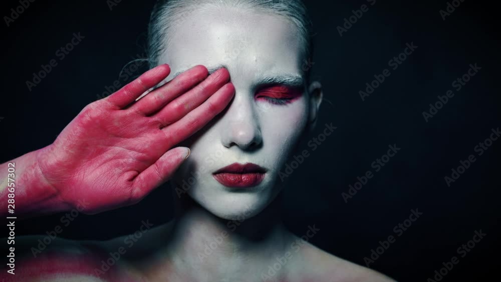 Mystery weird girl close half of her face with bloody hand Mystery weird girl close half of her face with bloody hand