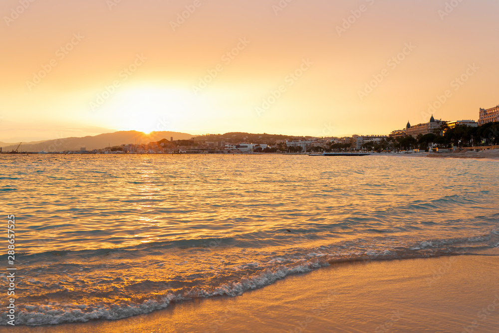 Sunset in Cannes, Cote d'Azur, France, South Europe. Nice city and luxury resort of French riviera. Famous tourist destination with nice beach and Promenade de la Croisette on Mediterranean sea