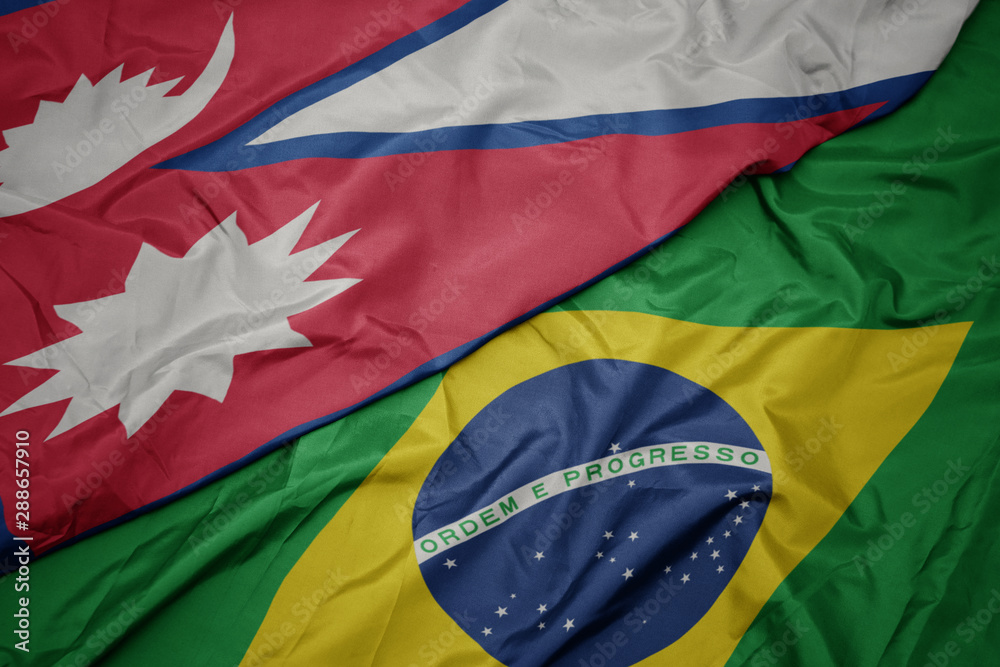 waving colorful flag of brazil and national flag of nepal.