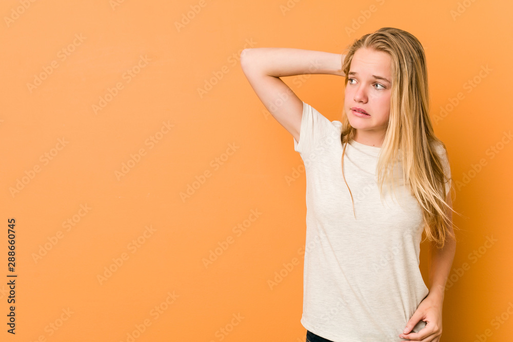 Cute and natural teenager woman touching back of head, thinking and making a choice. Cute and natural teenager woman touching back of head, thinking and making a choice.