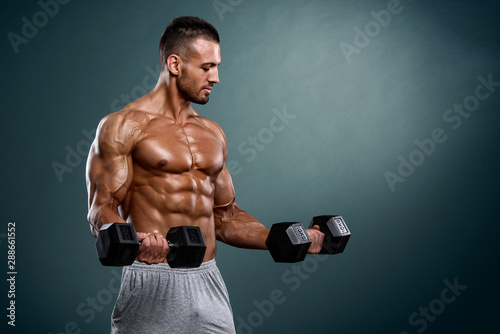 Muscular Men Lifting Weights. Studio Shot © mrbigphoto
