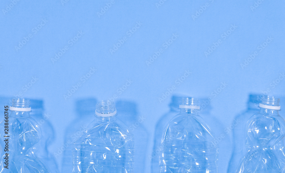 Plastic bottles isolated on blue background. Seamless pattern. Recycle waste management concept. Plastic Pet Bottles. Copy space Plastic bottles isolated on blue background. Seamless pattern. Recycle waste management concept. Plastic Pet Bottles. Copy space
