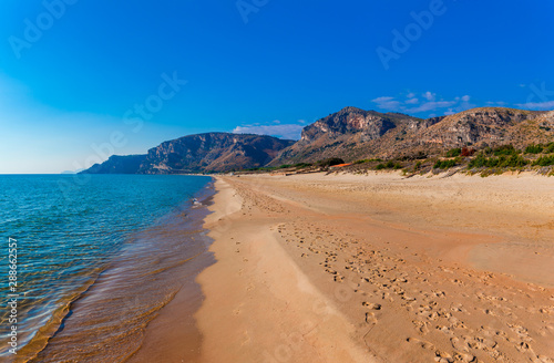 Panoramic sea beach landscape near Gaeta, Lazio, Italy. Nice sand beach and clear blue water. Famous tourist destination in Riviera de Ulisse. Bright sunny light and sunset. © oleg_p_100