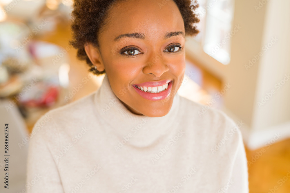 Beautiful young african american woman smiling confident to the camera showing teeth