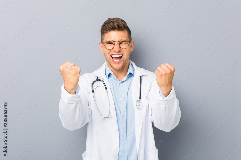 Young blonde doctor man cheering carefree and excited. Victory concept. Young blonde doctor man cheering carefree and excited. Victory concept.