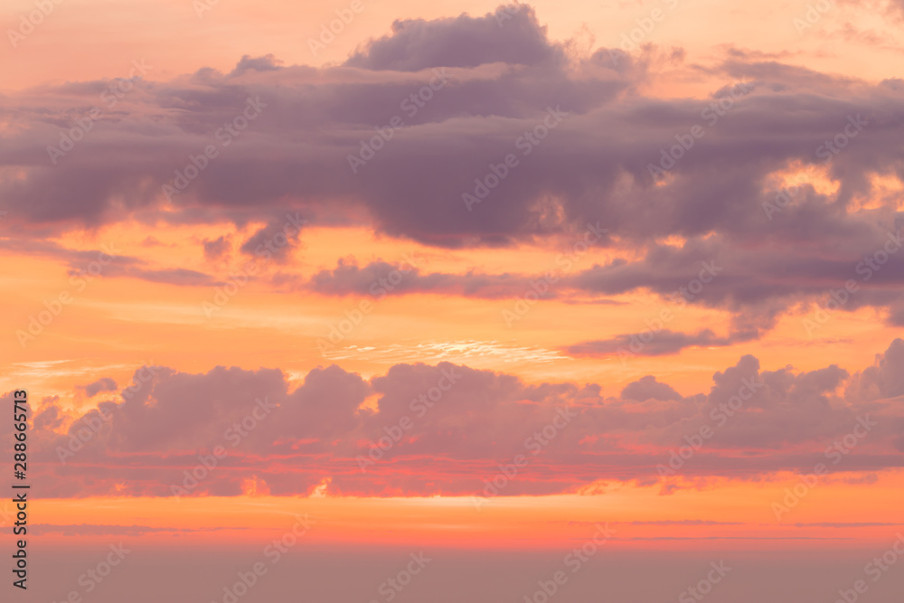 The sunset or sunrise. The cloudy sky cloured in red, orange, rose, scarlet, crimson, purple, violet and blue bright and vivid coloures in the evening or in the morning