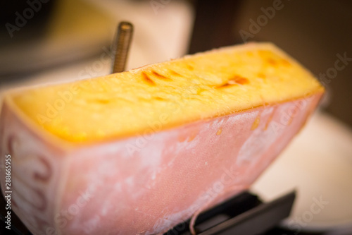 Half moon of melted raclette cheese