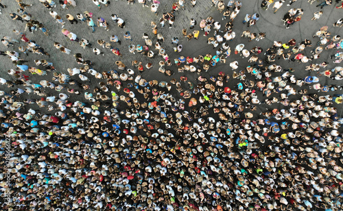Aerial. People crowd on a city square background. Top view.