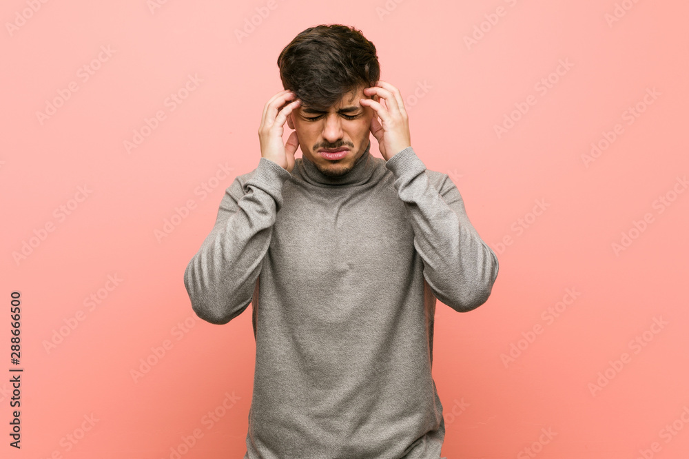 Young smart student man touching temples and having headache. Young smart student man touching temples and having headache.