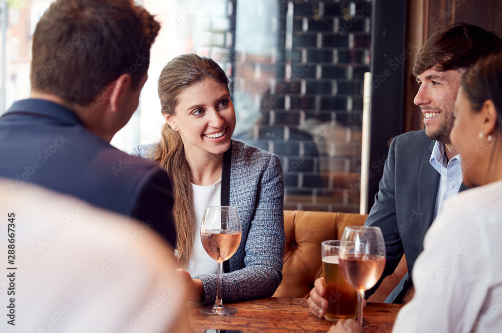 Group Of Business Colleagues Meeting For Drinks And Socializing In Bar After Work Group Of Business Colleagues Meeting For Drinks And Socializing In Bar After Work