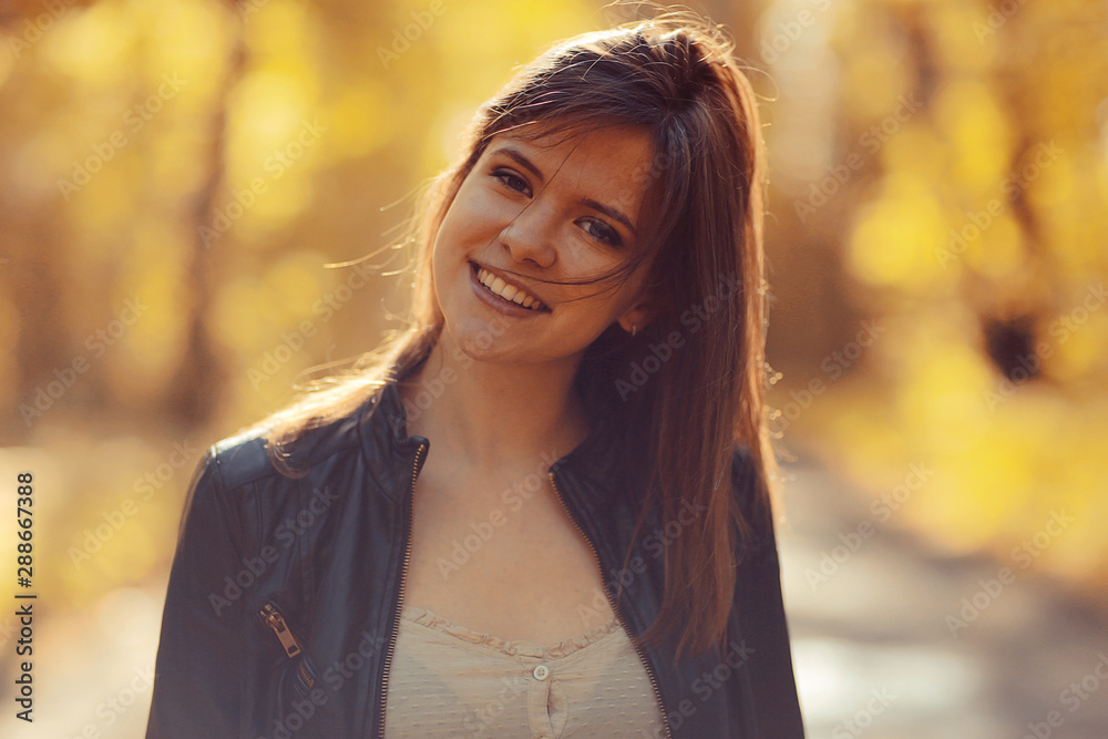 Young adult girl portrait in autumn park yellow leaves background Young adult girl portrait in autumn park yellow leaves background