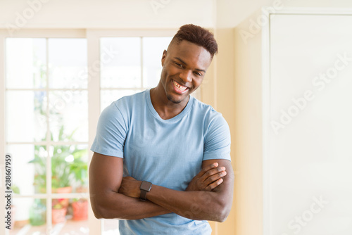 Handsome african young man smiling cheerful with crossed arms