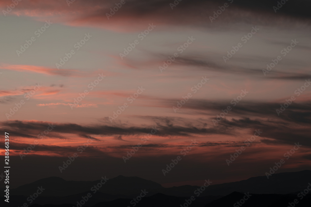 Pink sky with white cotton clouds