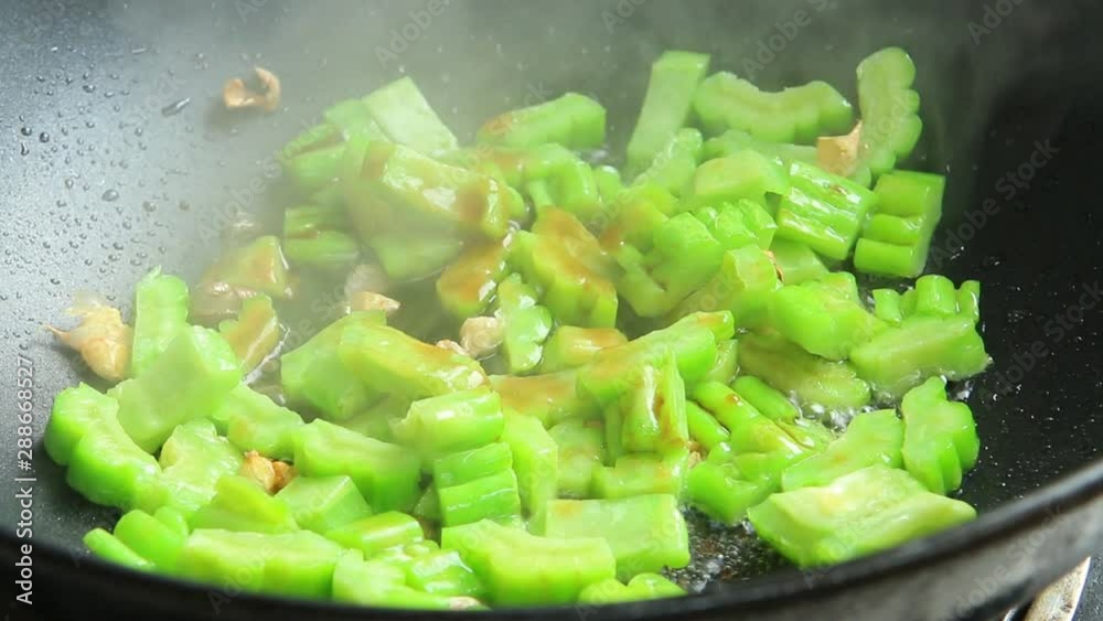 Frying bitter melon in pan, Chiangmai Thailand Frying bitter melon in pan, Chiangmai Thailand