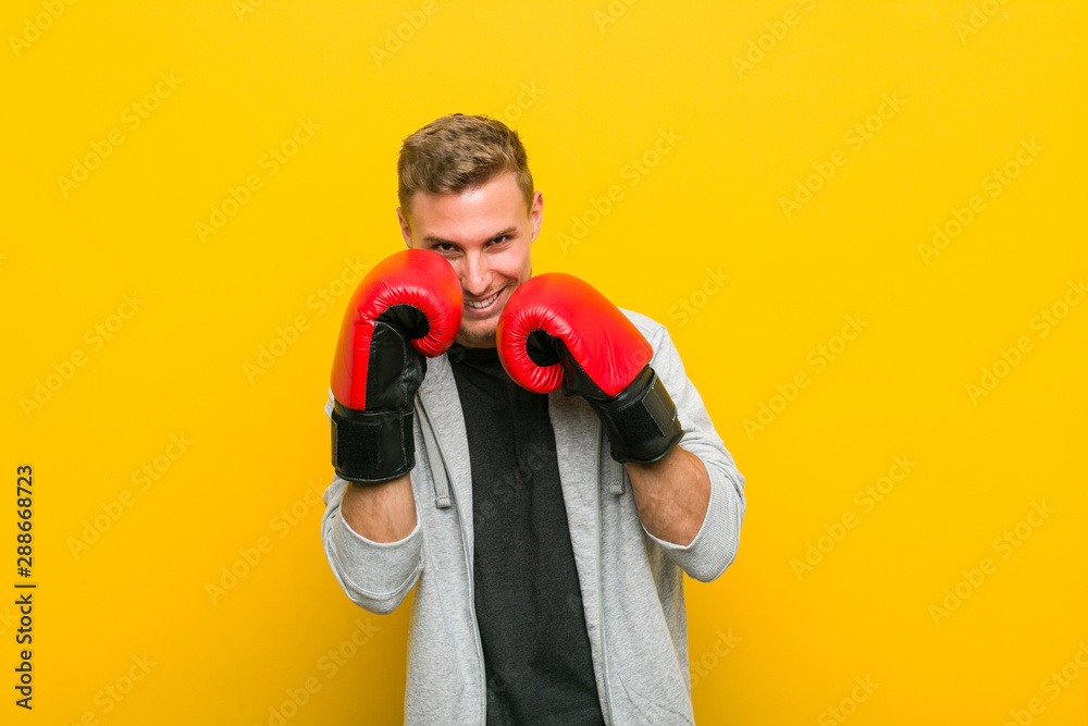 Young caucasian man wearing a boxing gloves Young caucasian man wearing a boxing gloves