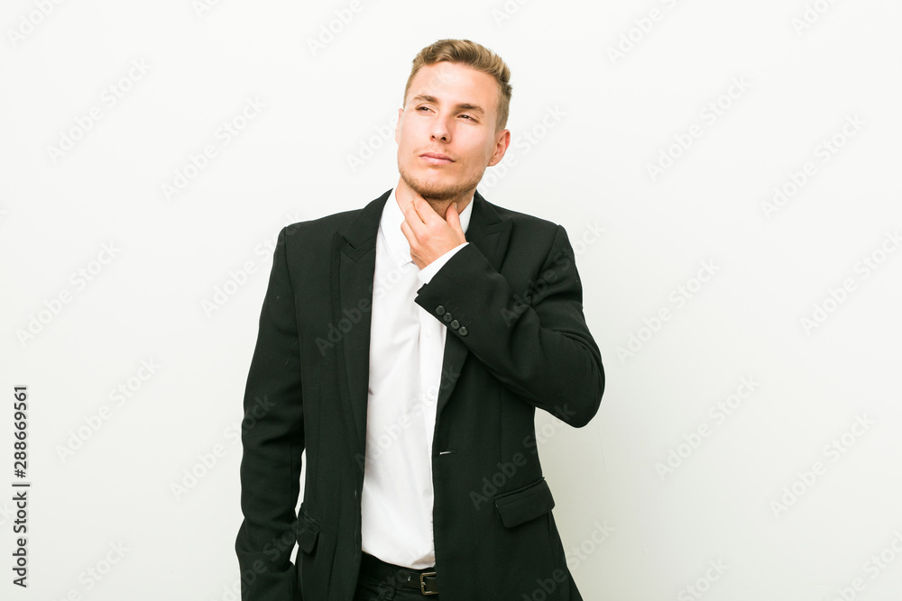 Young caucasian business man suffers pain in throat due a virus or infection. Young caucasian business man suffers pain in throat due a virus or infection.