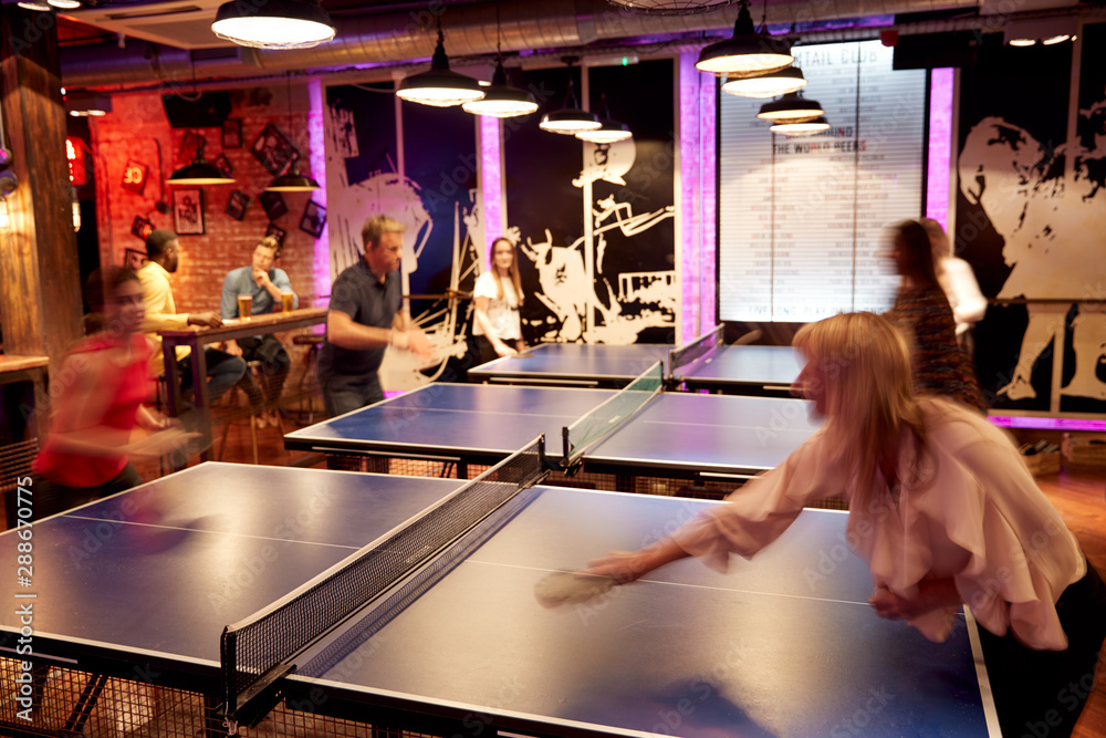 Interior Of Bar With Customers Drinking And Playing Table Tennis Stock
