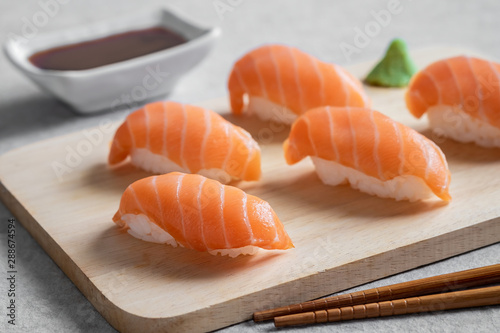 Salmon nigiri sushi on wooden plate, Japanese food