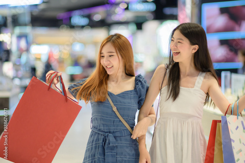 happy women and joyful and exciting in shopping mall center, buying and shopping consumerism, discount and sale period for customer shopping.