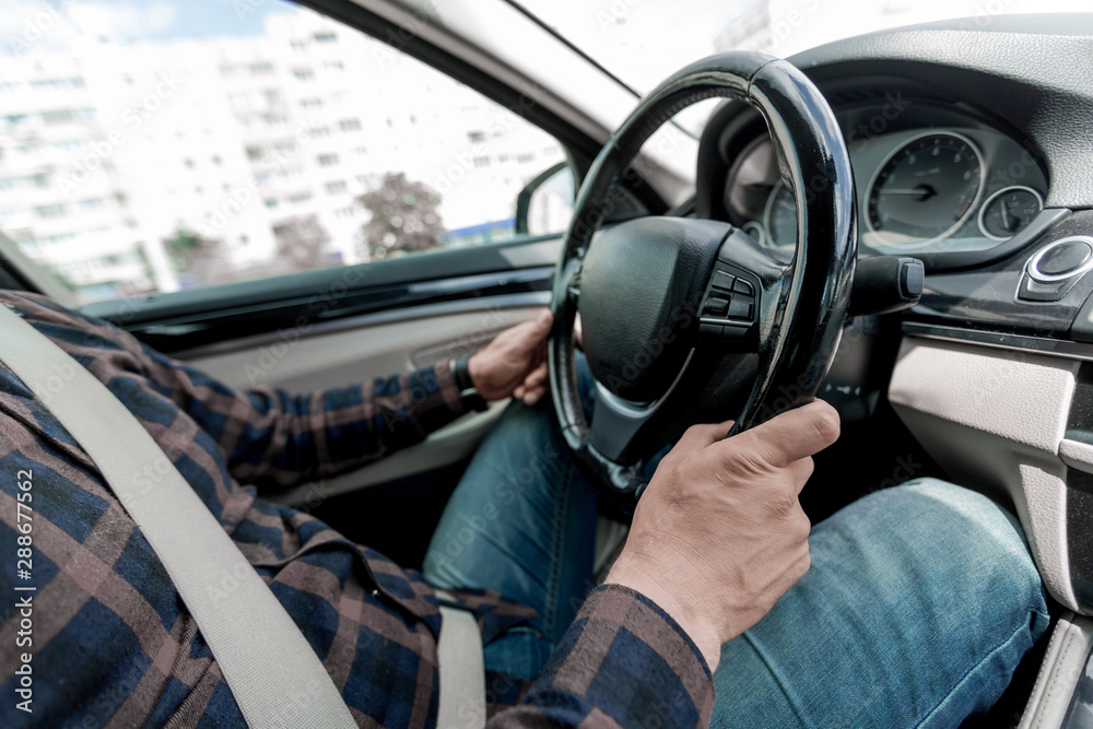 close up. a man sitting behind the wheel of a car. close up. a man sitting behind the wheel of a car.