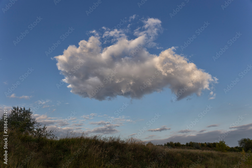 a large cloud hangs over the field. a large cloud hangs over the field.