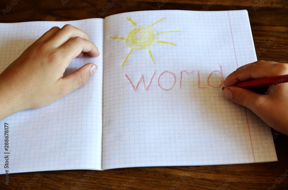 Multi-colored pencils. The child draws on white paper.