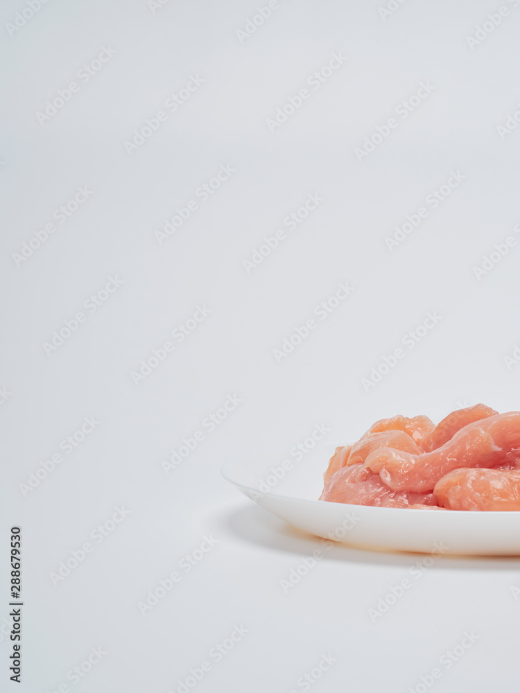 Fresh chicken tenderloin in white plate Fresh chicken tenderloin in white plate