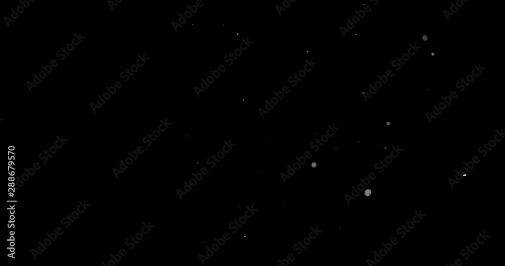 Flying dust particles on a black background Flying dust particles on a black background
